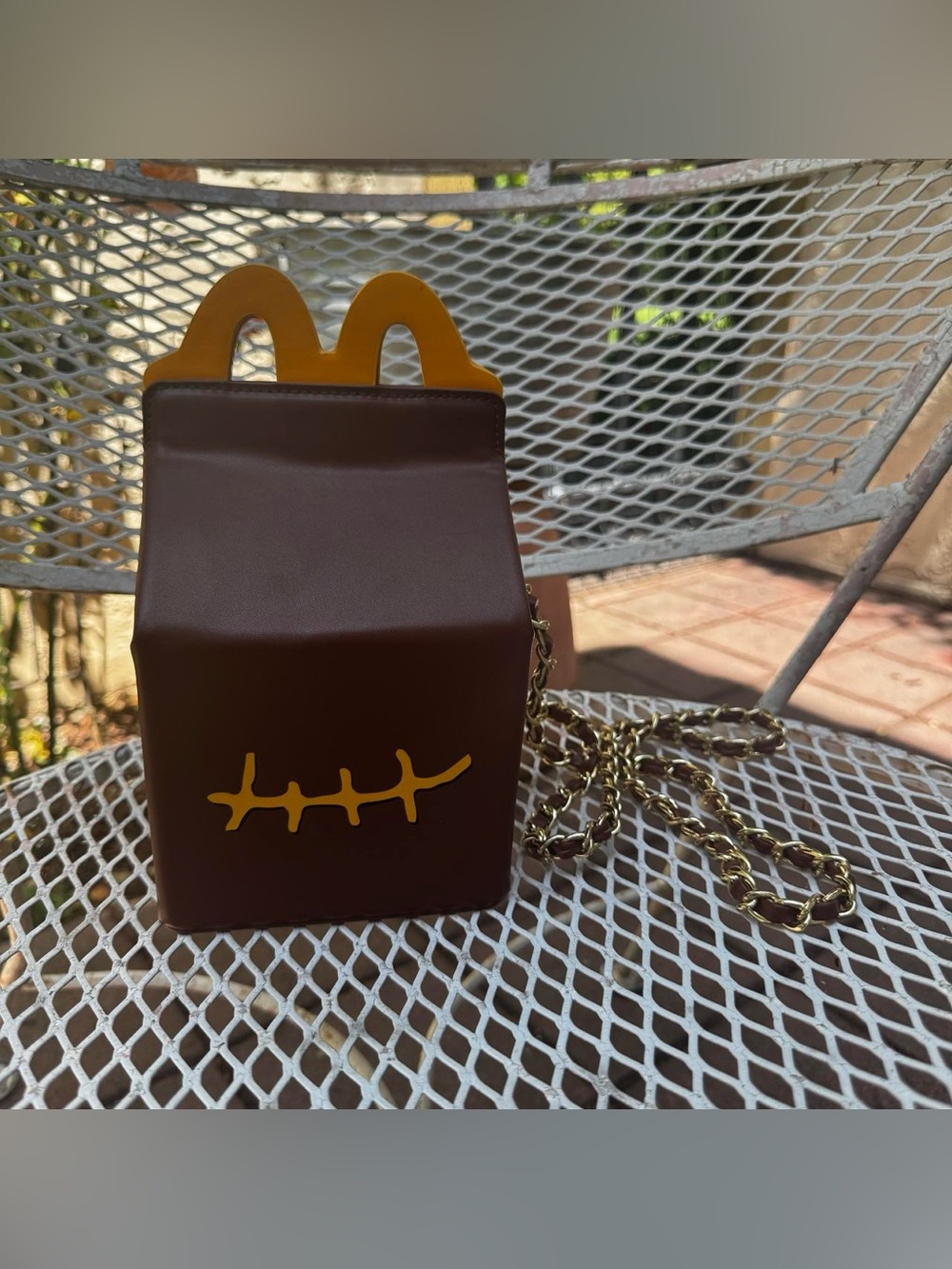 This is a Cactus Jack by Travis Scott x McDonald's Smile Clutch